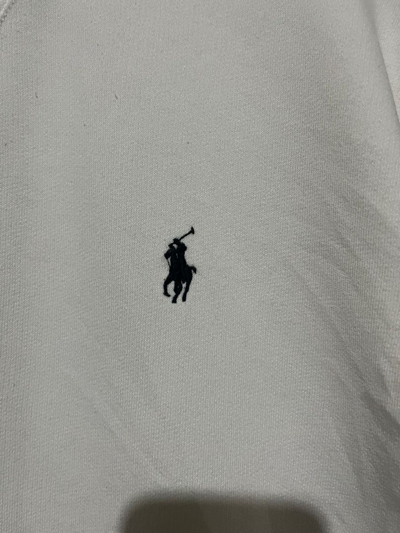 Polo Ralph Lauren White Sweatshirt (Category: Coats, Jackets and Outerwear) located in Valencia. Submitted by vncnttroy (Listing ID 1469439015, Image 2). Description: - Brand: Polo Ralph Lauren - Color: Crisp white - Design: Classic crewneck with V-stitch detail - Branding: Small embroidered dark pony logo on the left chest - Details: Long sleeves, ribbed cuffs and hem, blue label with QR code tags - Style: Versatile casual piece, perfect with je