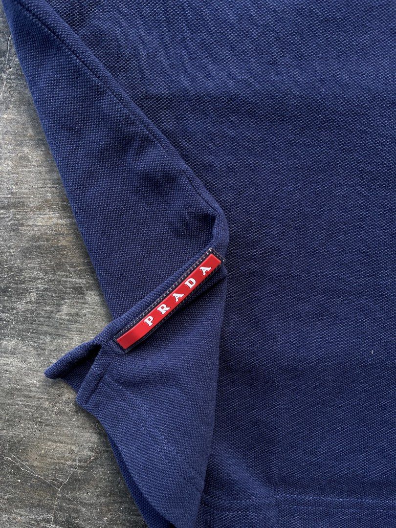 Pr4da Navy Blue Polo Shirt (Category: Tshirts & Polo Shirts ) located in Kalibo. Submitted by notdavaaa (Listing ID 1469498337, Image 3). Description: Size: Medium fittings Dimes: W: 19 L: 27 Excellent condition, cut washtag Color Rate: 9.8/10.