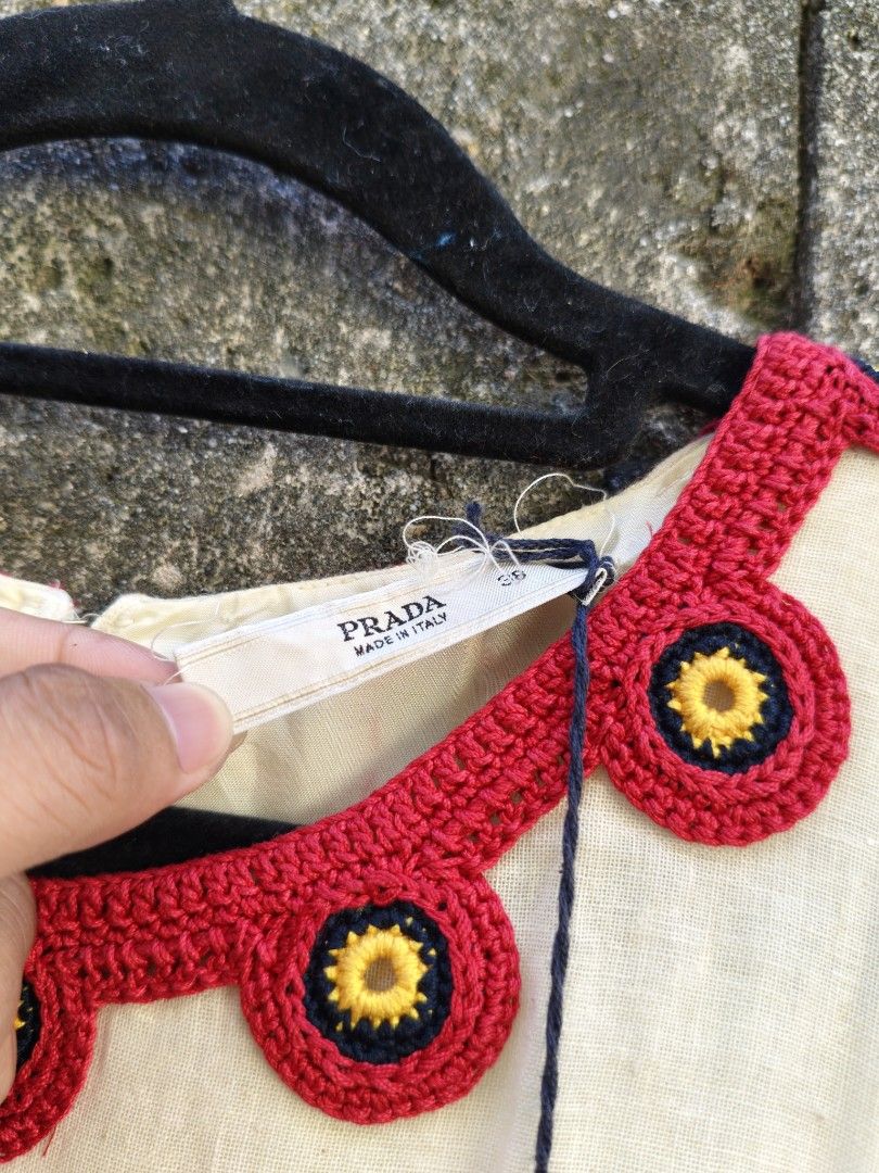 Prada Dress Size 38 (Category: Dresses) located in Bacolod City. Submitted by luciddreams07 (Listing ID 1469458004, Image 3). Description: - Brand: Prada - Style: Sleeveless pleated dress - Color: Cream with red crocheted neckline & floral accents - Size: 38 (Made in Italy) - Condition: Brand new with original tag attached - Details: Pleated skirt with matching round appliques along the bottom hem - Perfect for: Special occasions, dates, or brunc