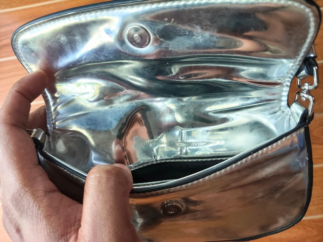 Prada metallic silver shoulder bag (Category: Luxury Bags & Wallets) located in Caloocan City. Submitted by balizaclar77072 (Listing ID 1469491785, Image 3). Description: - Authentic Prada shoulder bag in a chic metallic silver finish - Secure flap closure with magnetic snap and silver-tone hardware - Matching metallic interior lining featuring the iconic Prada Made in Italy metal plaque - Compact size, ideal for carrying daily essentials or for 