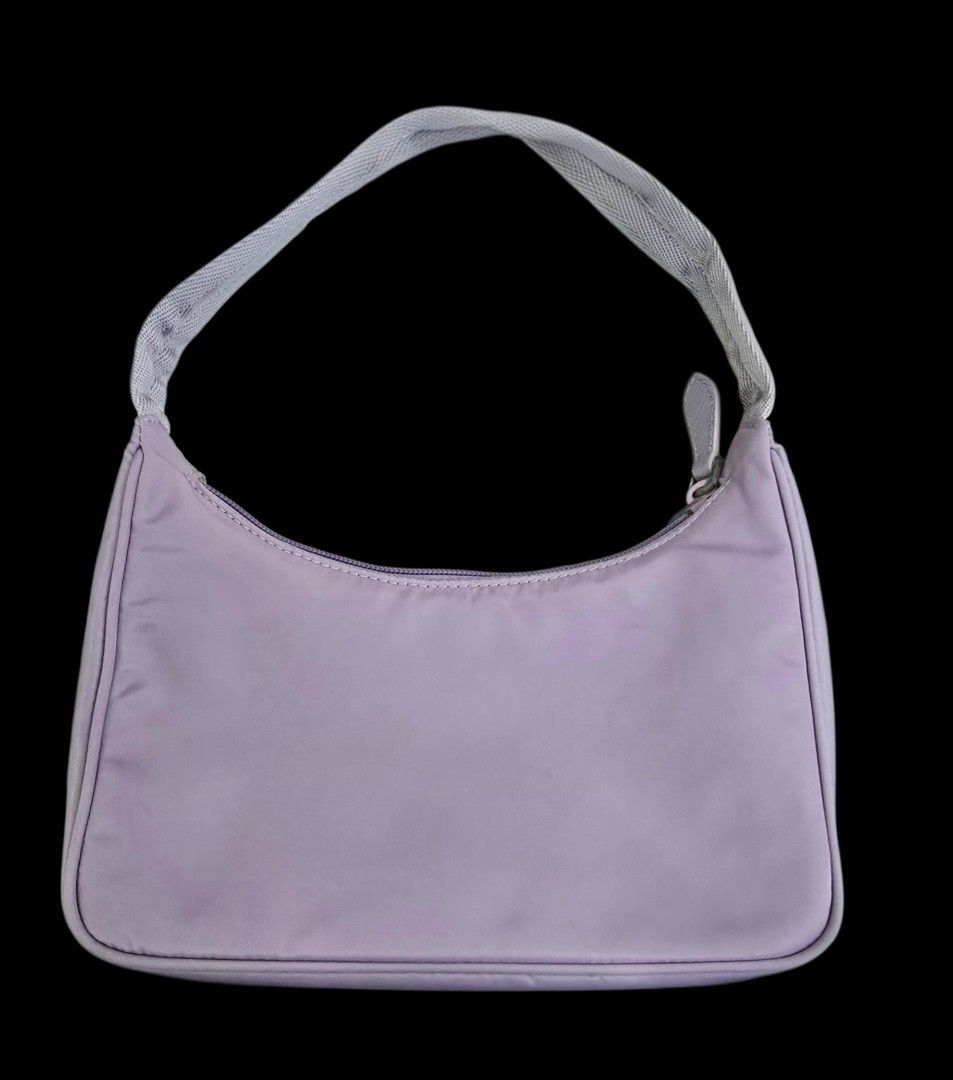 Prada Nylon Mini Bag Lavender (Category: Luxury Bags & Wallets) located in Manila. Submitted by brandedshoppe_mnl (Listing ID 1469523201, Image 2). Description: - Brand: Authentic VintagePrada - Material: Durable nylon in a gorgeous lavender shade - Hardware: Silver-tone with classic front triangular logo plaque - Closure: Zip-top secure closure - Interior: Branded jacquard lining with a convenient inside pocket - Strap: Short shoulder strap feat