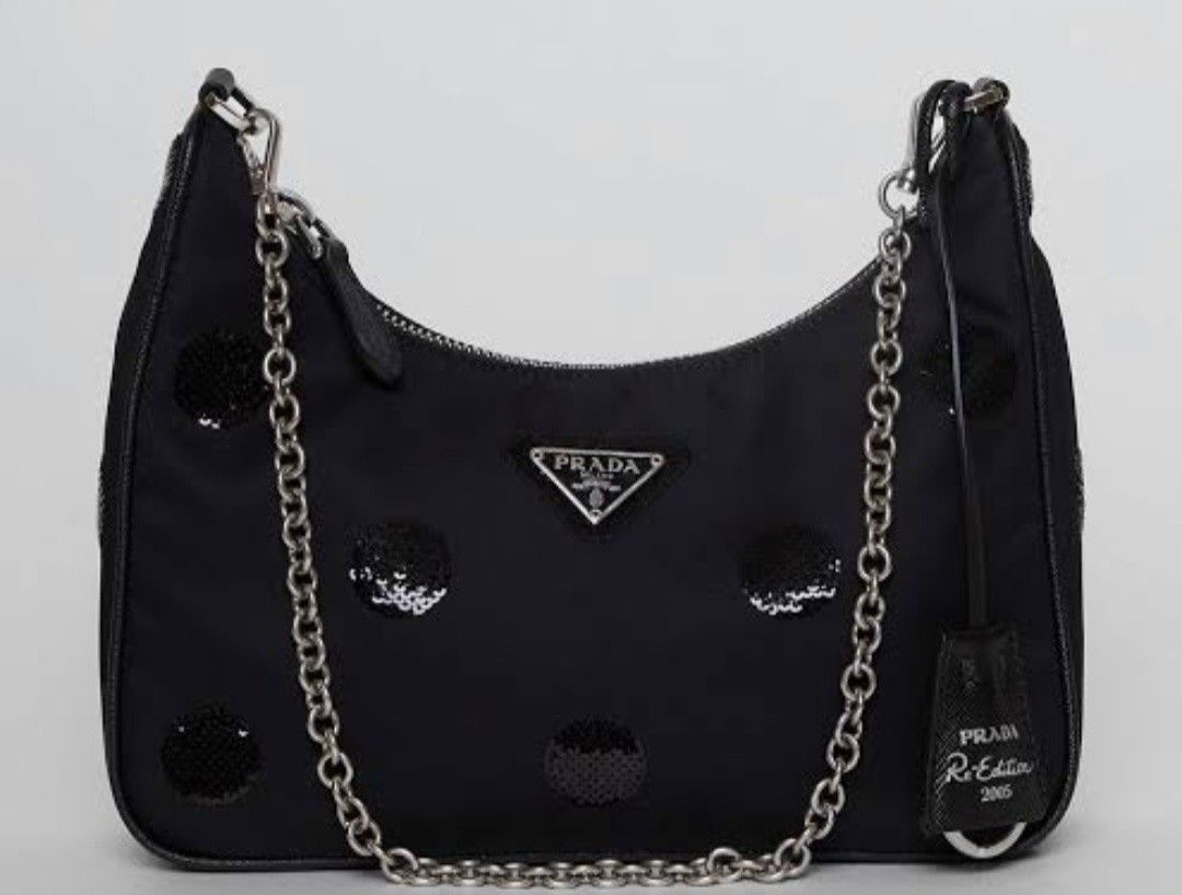 Prada Re-Edition 2005 Black Nylon Polka Dot Sequin Shoulder Bag (Category: Luxury Bags & Wallets) located in Manila. Submitted by brandedshoppe_mnl (Listing ID 1469522705, Image 1). Description: - Authentic Prada Re-Edition 2005 shoulder bag -Preloved/Used - Black nylon body covered in stylish black sequin polka dots - Silver-tone hardware with matching chain strap and small keychain pouch - Secure top zip closure - Fabric-lined interior with "Ma