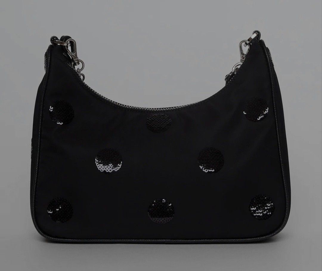 Prada Re-Edition 2005 Black Nylon Polka Dot Sequin Shoulder Bag (Category: Luxury Bags & Wallets) located in Manila. Submitted by brandedshoppe_mnl (Listing ID 1469522705, Image 2). Description: - Authentic Prada Re-Edition 2005 shoulder bag -Preloved/Used - Black nylon body covered in stylish black sequin polka dots - Silver-tone hardware with matching chain strap and small keychain pouch - Secure top zip closure - Fabric-lined interior with "Ma