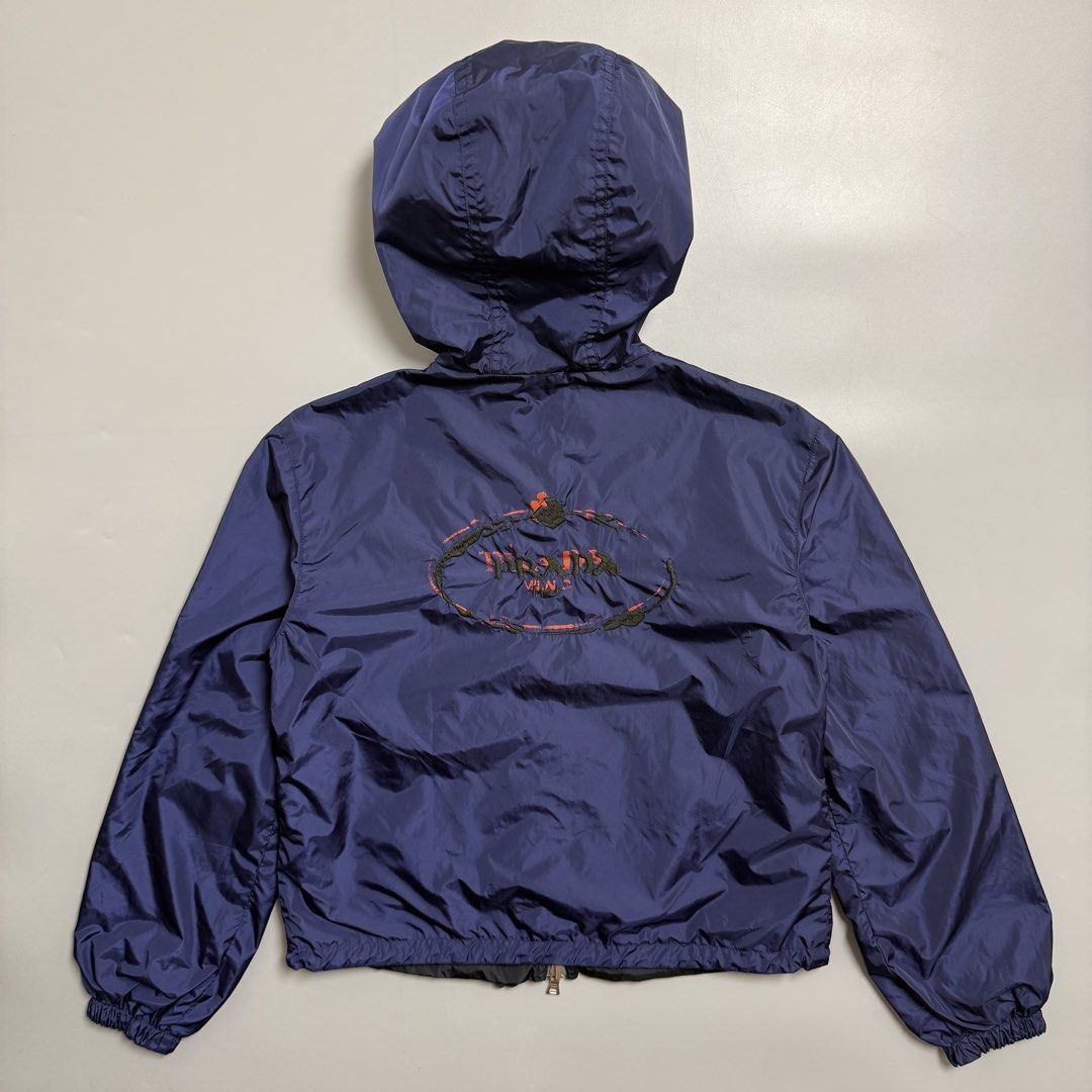 Prada Reversible Nylon Navy/Black Embroidered Light Jacket (Category: Coats, Jackets and Outerwear) located in Cebu City. Submitted by inukaybyjlf (Listing ID 1469560990, Image 2). Description: Condition: Good as new Issue: No flaws Dimensions: 18.4x20 Best fit: S-M Please refer to photos for actual condition .