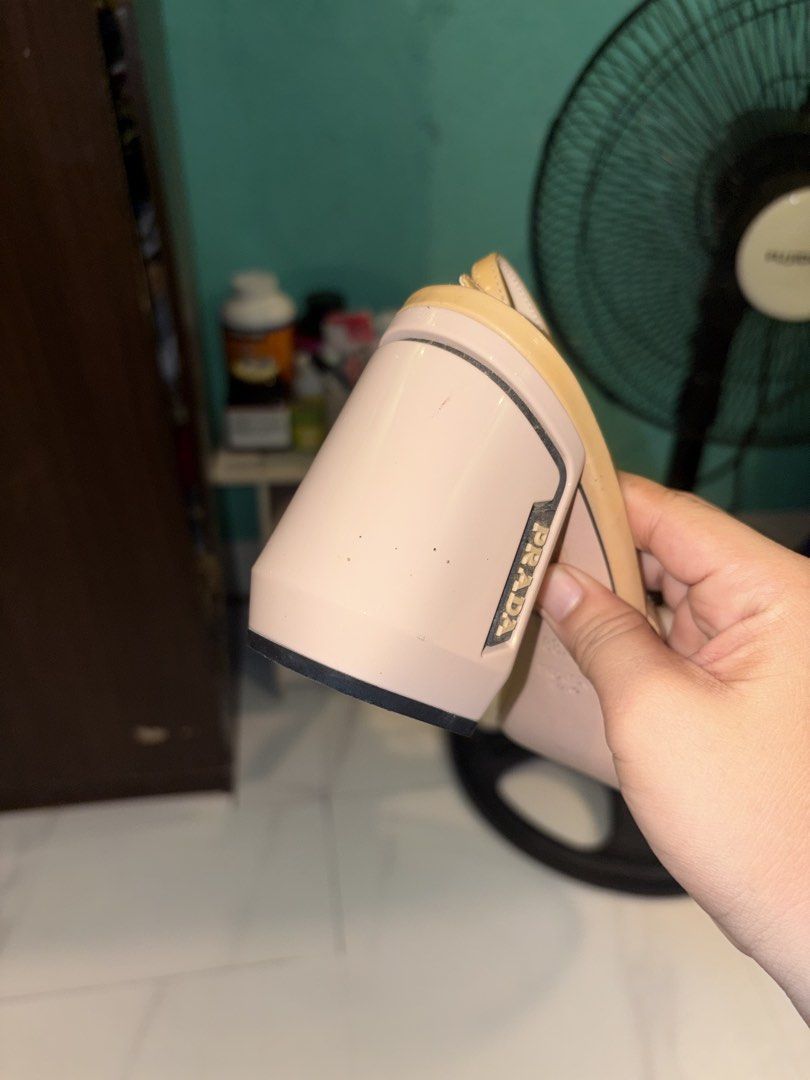 Prada Slingback Block Heel Pumps Beige Black Size 38.5 (Category: Heels) located in San Quintin. Submitted by angelcabarloc (Listing ID 1469425821, Image 3). Description: - Brand: Prada - Style: Slingback block heels - Colorway: Classic beige and black with cream insole and blue Prada label - Size: 38.5 (stamped inside) - Details: Iconic Prada logo plaque on the side, adjustable buckle slingback strap - Condition: Pre-owned with minor scuffs and 