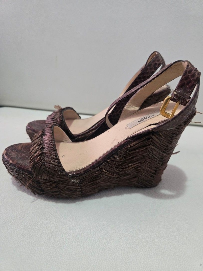 Prada Wedge Sandals Size 38 Brown Python Skin (Category: Flats & Sandals) located in Paranaque City. Submitted by shein07 (Listing ID 1469401376, Image 2). Description: - Brand: Prada - Style: Wedge sandals with ankle strap and buckle closure - Material: Brown python skin finish with straw/raffia textured details - Hardware: Gold-tone - Size: 38 (Made in Italy) - Condition: Lightly worn soles, with noticeable wear and fraying on the woven texture