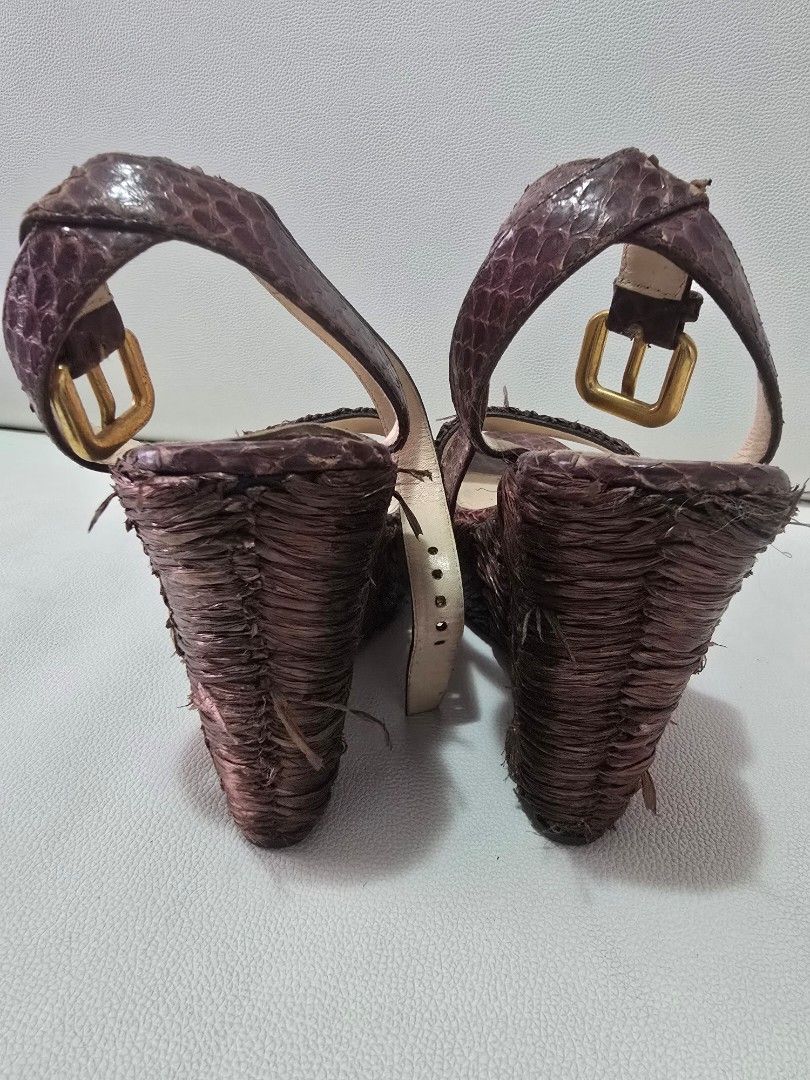 Prada Wedge Sandals Size 38 Brown Python Skin (Category: Flats & Sandals) located in Paranaque City. Submitted by shein07 (Listing ID 1469401376, Image 3). Description: - Brand: Prada - Style: Wedge sandals with ankle strap and buckle closure - Material: Brown python skin finish with straw/raffia textured details - Hardware: Gold-tone - Size: 38 (Made in Italy) - Condition: Lightly worn soles, with noticeable wear and fraying on the woven texture
