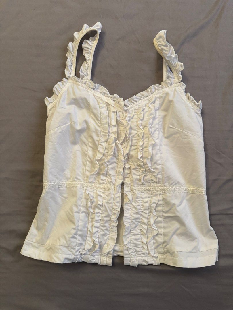 Pradies white ruffled sleeveless top (Category: Sleeveless) located in Pasig City. Submitted by katsud0oon (Listing ID 1469444904, Image 1). Description: Viet brand. Worn once only. See photos for dimensions but will fit S-M .