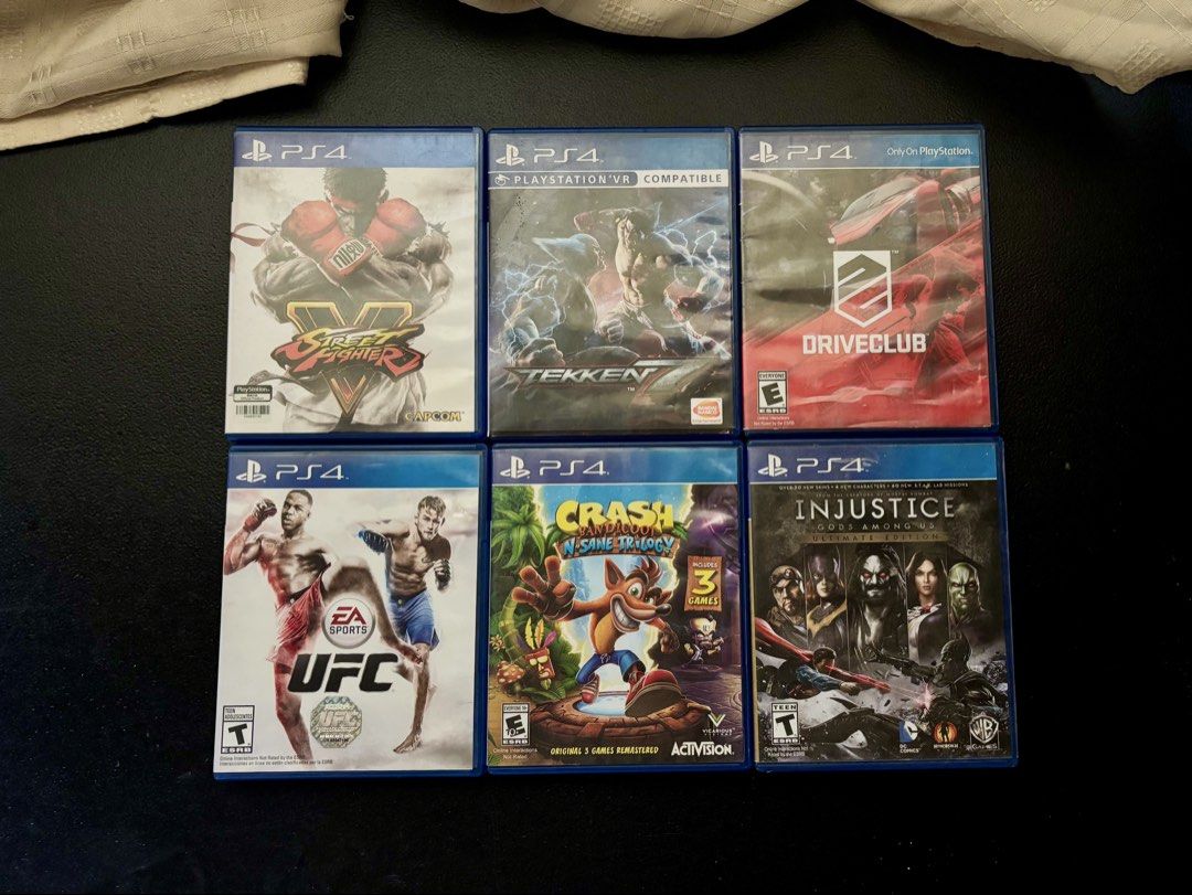 PS4 Games Bundle and Gold DualShock 4 Controller (Category: PlayStation) located in Manila. Submitted by jarrd.xx (Listing ID 1469406358, Image 1). Description: - PS4 gaming bundle in great working condition - Includes 6 popular game discs: Street Fighter V, Tekken 7, Driveclub, EA Sports UFC, Crash Bandicoot N. Sane Trilogy, and Injustice Gods Among Us Ultimate Edition - Comes with an official Sony DualShock 4 wireless controller in a stylish go
