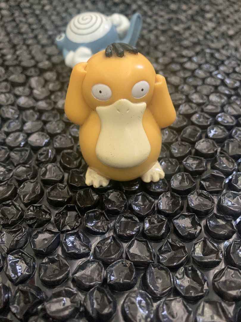 Psyduck Pokémon mini figure collectible toy (Category: Designer & Blind Box Toys) located in Manila. Submitted by emenem.m (Listing ID 1469420287, Image 1). Description: - Yellow Psyduck toy figure in classic head-in-hands pose - Features detailed white beak, feet, and signature hair tufts - Great addition to any Pokémon collection - Note: Poliwhirl figure in background is not included.