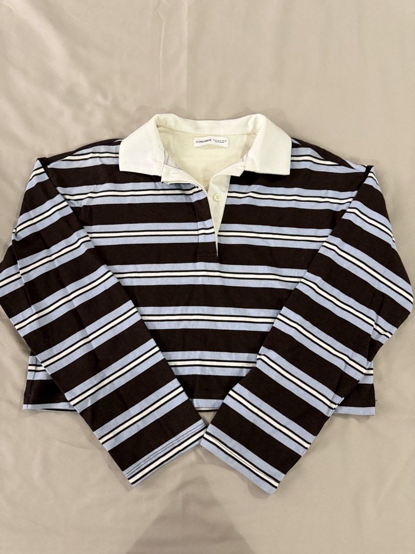 Pull&Bear Striped Long Sleeve Polo Shirt Size S (Category: Longsleeves) located in Caloocan City. Submitted by triciadrilvs (Listing ID 1469440753, Image 1). Description: - Brand: Pull&Bear - Style: Long sleeve polo shirt with brown, light blue, and white horizontal stripes - Details: Contrasting white collar and single-button placket - Size: S - Origin: Made in Morocco - Flaw: Noticeable yellowing and discoloration around the inner neckline and 