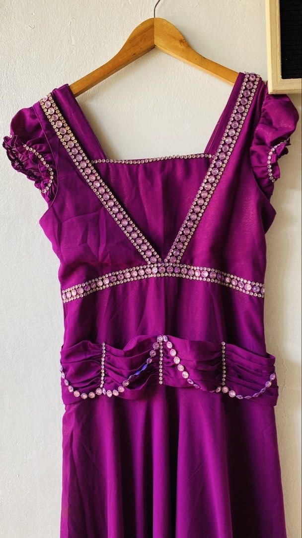 Purple Evening Dress with Rhinestone (Category: Evening dresses & gowns) located in Caloocan City. Submitted by lovemyclothes21 (Listing ID 1469463255, Image 3). Description: - Size: Medium - Color: Vibrant deep purple - Neckline: Square neck framed with sparkling pink rhinestones - Sleeves: Short ruffled sleeves - Details: Matching rhinestone trim on bodice and waistline, gathered fabric belt - Closure: Back zipper - Condition: Brand new/Excelle
