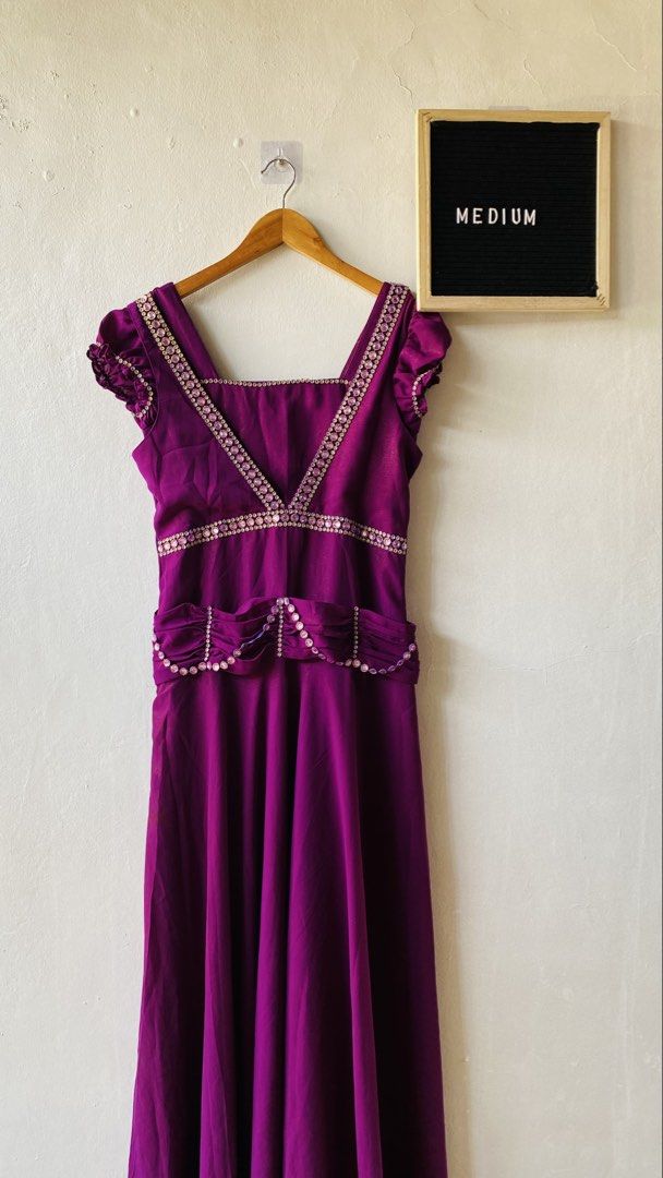 Purple Evening Dress with Rhinestone (Category: Evening dresses & gowns) located in Caloocan City. Submitted by lovemyclothes21 (Listing ID 1469463255, Image 2). Description: - Size: Medium - Color: Vibrant deep purple - Neckline: Square neck framed with sparkling pink rhinestones - Sleeves: Short ruffled sleeves - Details: Matching rhinestone trim on bodice and waistline, gathered fabric belt - Closure: Back zipper - Condition: Brand new/Excelle
