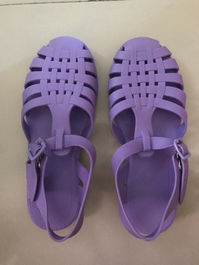 Purple Jelly Sandals (Category: Flats & Sandals) located in Imus. Submitted by mrsz3r0 (Listing ID 1469435103, Image 1). Description: - Color: Purple - Size: EUR 36 / BRA 34 / USA 5 (Model 2043) - Material: Flexible rubber for easy slip-on wear - Design: Woven lattice straps with adjustable ankle buckle closure - Comfort & Safety: Textured footbed and studded anti-slip outsole - Condition: Like new, clean soles with no signs of wear.