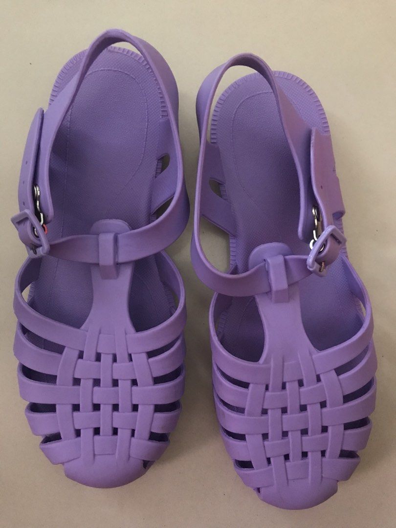 Purple Jelly Sandals (Category: Flats & Sandals) located in Imus. Submitted by mrsz3r0 (Listing ID 1469435103, Image 2). Description: - Color: Purple - Size: EUR 36 / BRA 34 / USA 5 (Model 2043) - Material: Flexible rubber for easy slip-on wear - Design: Woven lattice straps with adjustable ankle buckle closure - Comfort & Safety: Textured footbed and studded anti-slip outsole - Condition: Like new, clean soles with no signs of wear.