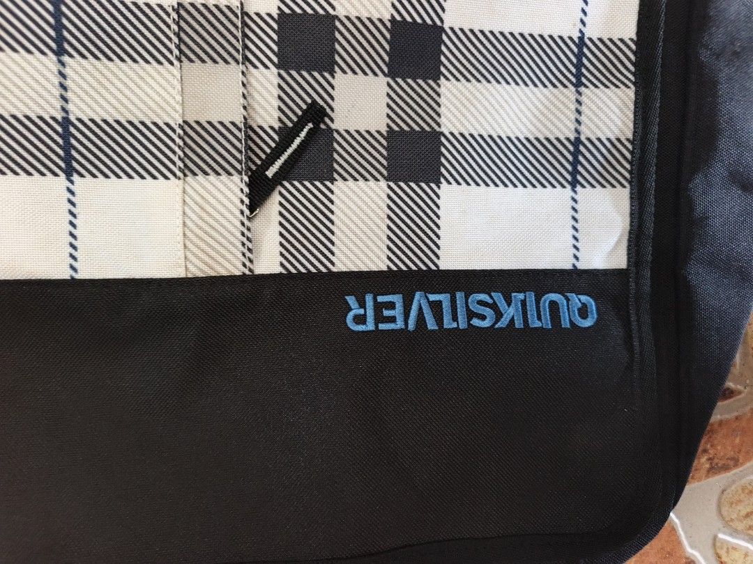 Quiksilver Plaid Messenger Bag Black White (Category: Sling Bags) located in Bayombong. Submitted by onlygoodfinds. (Listing ID 1469408883, Image 2). Description: - Authentic Quiksilver messenger bag - Stylish plaid flap with durable black lower panel and blue embroidered logo - Spacious main compartment with black fabric lining - Extra interior and exterior pockets for better organization - Adjustable shoulder strap with comfortable padded grip 