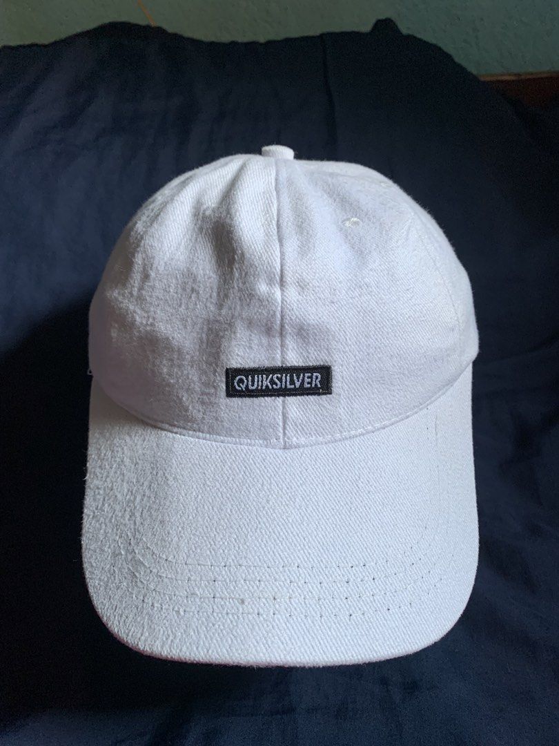 Quiksilver White Baseball Cap (Category: Caps & Hats) located in Manila. Submitted by silverbear_a65902 (Listing ID 1469398592, Image 2). Description: - Brand: Quiksilver - Color: Classic White - Design: Structured panels with curved brim - Details: Front branded patch and clean interior sweatband - Closure: Adjustable strap with metal buckle - Condition: Good,ready to wear Issue: little rust on strap but still good condition ready to use.
