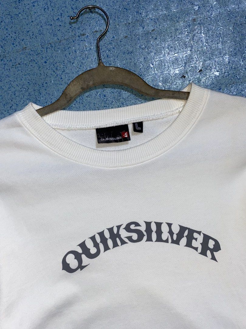 Quiksilver White Sweatshirt Size L (Category: Coats, Jackets and Outerwear) located in Manila. Submitted by jeproxthrift (Listing ID 1469558651, Image 2). Description: - Brand: Quiksilver - Color: White with dark grey chest graphic - Size: Large - Details: Ribbed collar, cuffs, and hem - Style: Clean, minimal surf-skate look; great for layering on cooler days.
