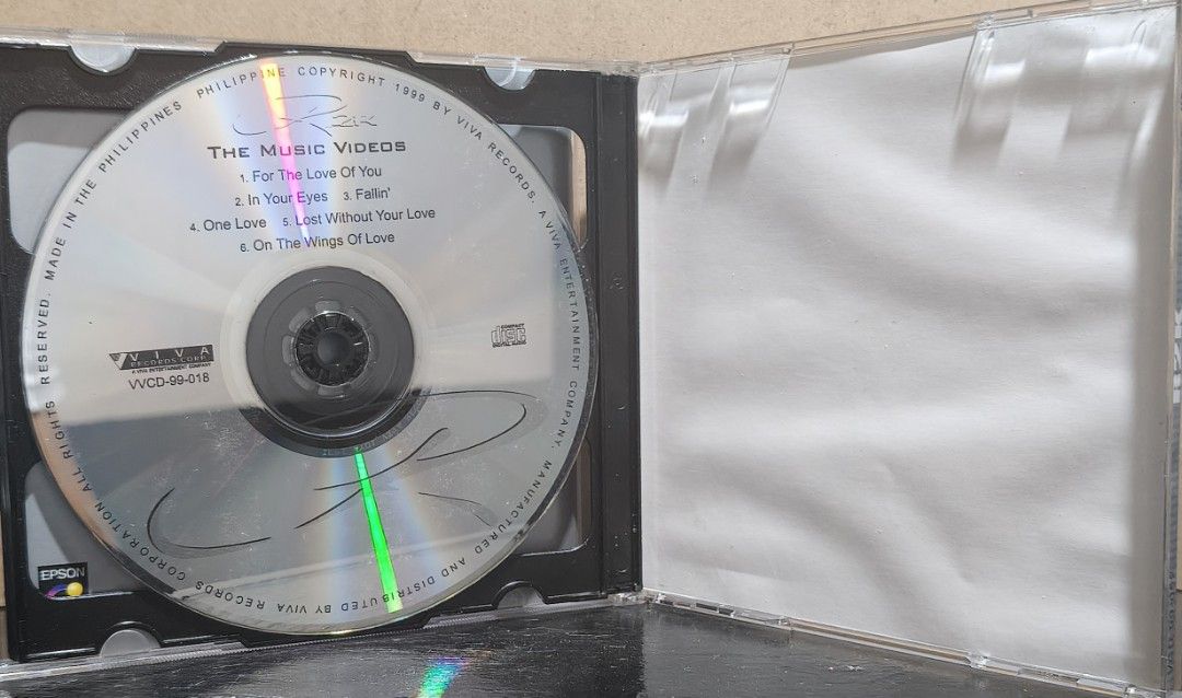 R2K CD Album Viva Records (Category: CDs & DVDs) located in Manila. Submitted by ruelcabrer77078 (Listing ID 1469555625, Image 3). Description: Regine Velasquez R2K album released by Viva Records in 1999. Includes jewel case, booklet insert printed on Epson transparency paper, and compact disc. Disc has handwritten markings in marker. Case has minor scratches from regular storage. Playable audio disc..