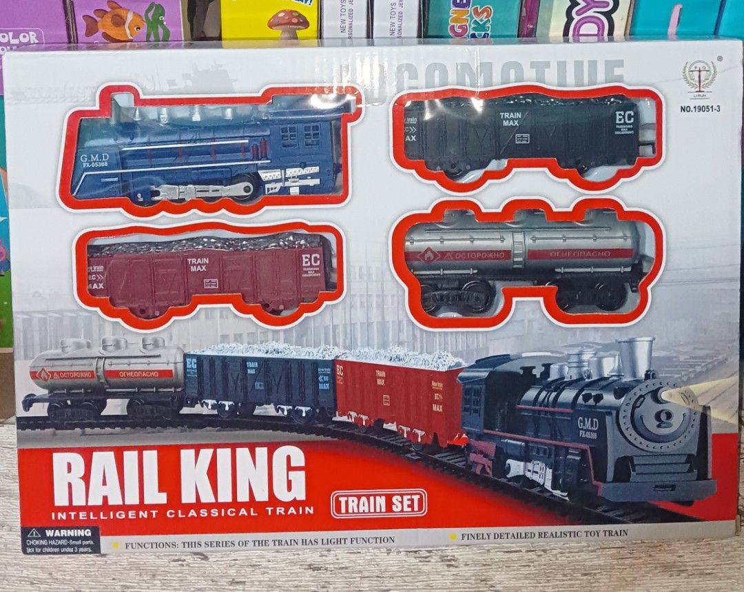 Rail King Intelligent Classical Train Set Battery Operated (Category: Action & Battle Toys) located in Pasig City. Submitted by benildarustia18 (Listing ID 1469534767, Image 1). Description: Rail King classic toy train set with locomotive, carriages, and track pieces. Assembled track measures 104cm by 68cm. Requires 2 AA batteries. Detailed realistic design with functional lights on the engine. Great gift for kids or toy train collectors. Origina