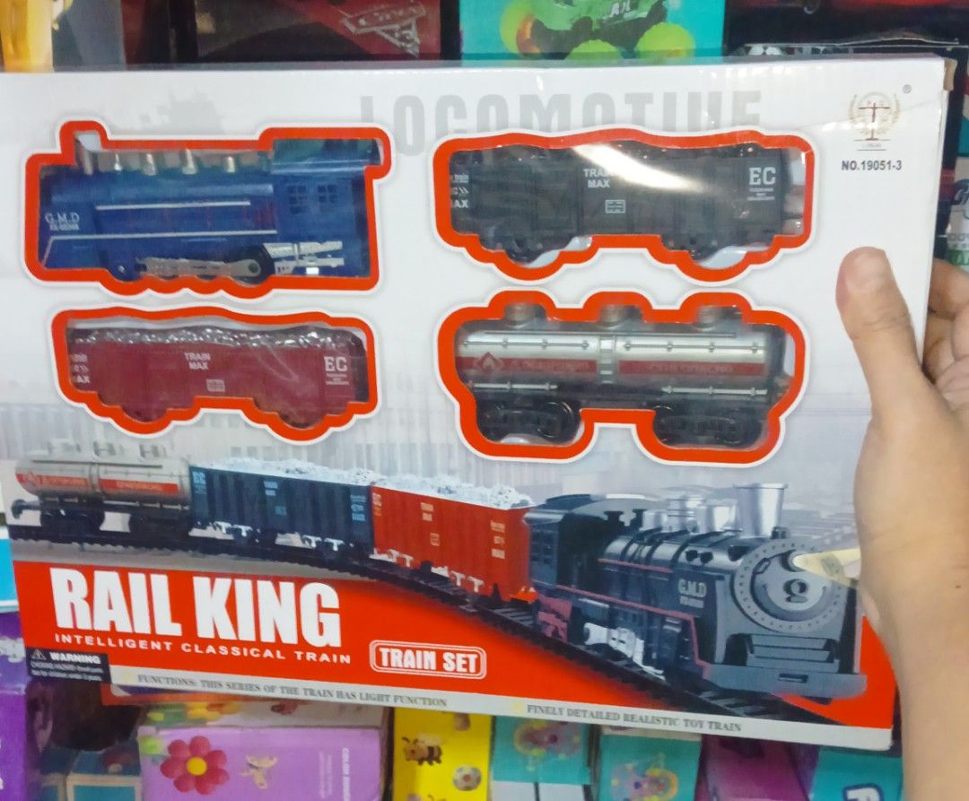 Rail King Intelligent Classical Train Set Battery Operated (Category: Action & Battle Toys) located in Pasig City. Submitted by benildarustia18 (Listing ID 1469534767, Image 2). Description: Rail King classic toy train set with locomotive, carriages, and track pieces. Assembled track measures 104cm by 68cm. Requires 2 AA batteries. Detailed realistic design with functional lights on the engine. Great gift for kids or toy train collectors. Origina