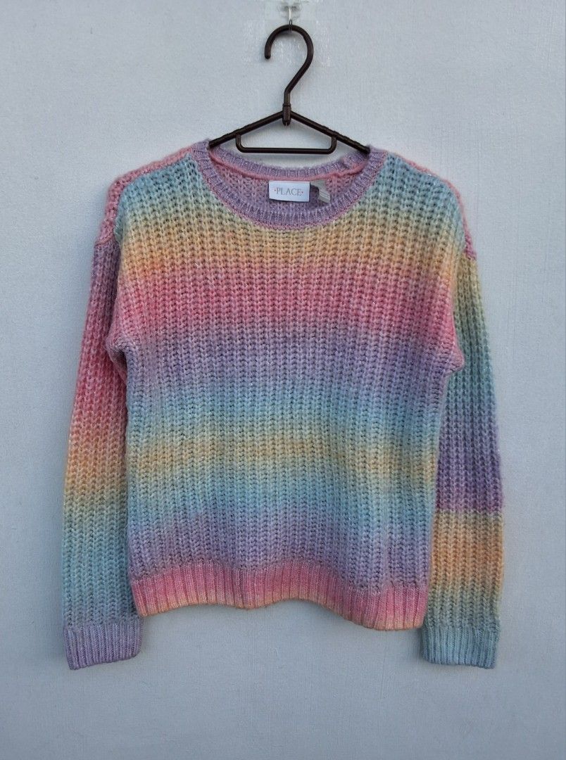 Rainbow Pastel Sweater (Category: Longsleeves) located in Makati City. Submitted by justget8 (Listing ID 1469530487, Image 1). Description: - Design: Pastel rainbow striped knit sweater with soft color gradient (pink, yellow, blue, purple) - Texture: Chunky ribbed texture for extra coziness - Features: Long sleeves and classic crew neckline - Use: Great layering piece for cooler weather.