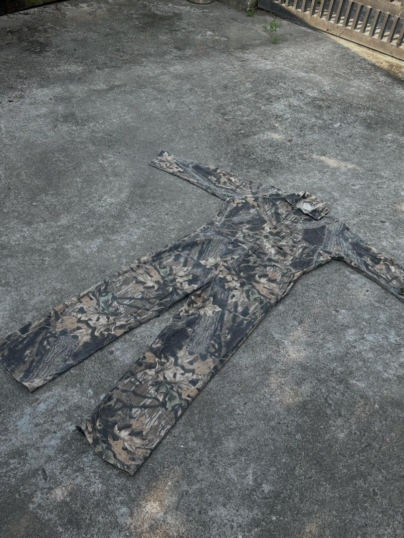 RealTree Camo BreakUp Pattern All In One Jumpsuit (Category: Jumpsuits) located in Makati City. Submitted by chichi_buka888 (Listing ID 1469502789, Image 2). Description: - Authentic RealTree BreakUp camouflage pattern with realistic tree bark and leaf print - All-in-one jumpsuit design with long sleeves and a collared neckline - Multiple functional pockets on the chest and back for easy storage - Durable, heavy-duty fabric built for outdoor work