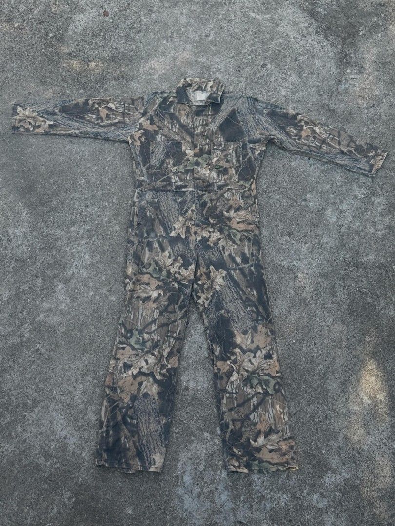 RealTree Camo BreakUp Pattern All In One Jumpsuit (Category: Jumpsuits) located in Makati City. Submitted by chichi_buka888 (Listing ID 1469502789, Image 1). Description: - Authentic RealTree BreakUp camouflage pattern with realistic tree bark and leaf print - All-in-one jumpsuit design with long sleeves and a collared neckline - Multiple functional pockets on the chest and back for easy storage - Durable, heavy-duty fabric built for outdoor work