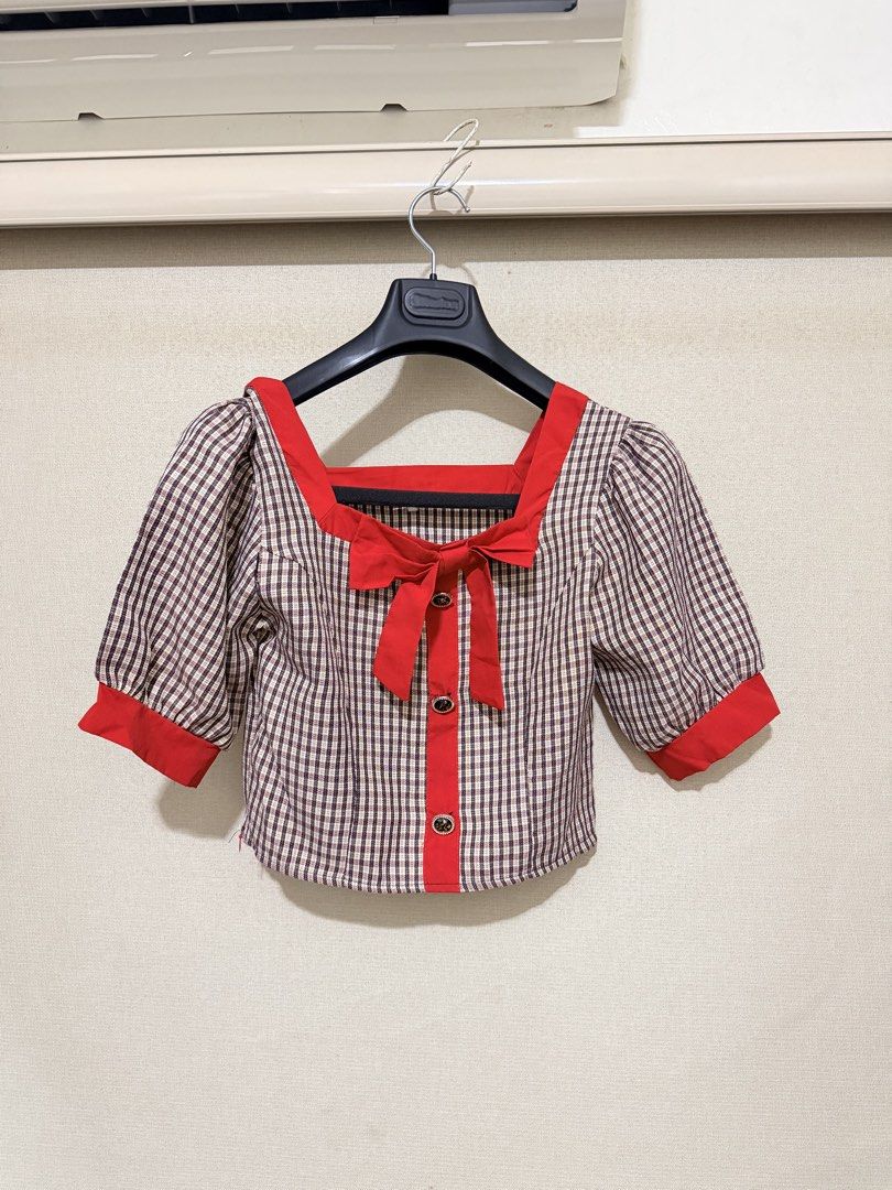 Red and Plaid Square Neck Crop Top with Bow (Category: Blouses) located in Cavite. Submitted by mgd.blessed (Listing ID 1469435586, Image 1). Description: - Brown and white plaid short-sleeve crop top - Bold red square collar, sleeve cuffs, and center placket - Sweet red bow tied at the neckline - Three decorative buttons down the front - Playful puff sleeves for a stylish look - Perfect for casual outings and dates - Pairs great with high-waiste