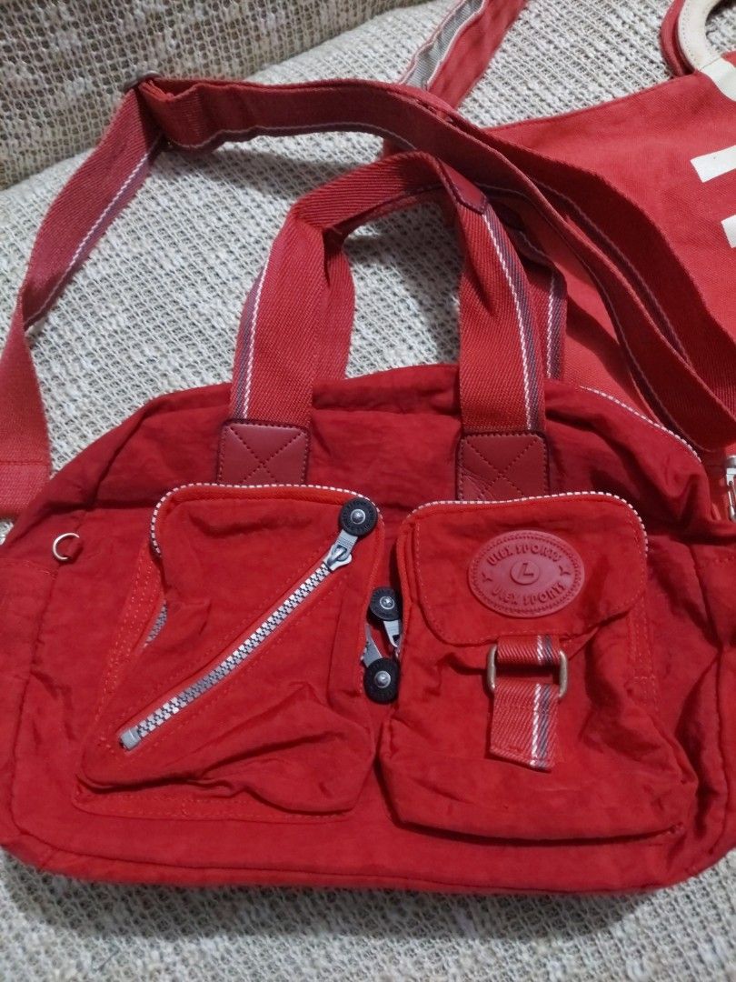 Red Anello Tote Bag and Red Shoulder Bag Bundle (Category: Tote Bags) located in Quezon City. Submitted by never_a_clutter (Listing ID 1469521952, Image 2). Description: - Bundle includes 2 versatile red bags - Bag 1: Large Anello canvas tote bag with bold white lettering - Bag 2: Ulex Brand Compact red fabric shoulder bag featuring multiple zippered front pockets and a round logo badge - Excellent daily carry options for work, school, or casual 