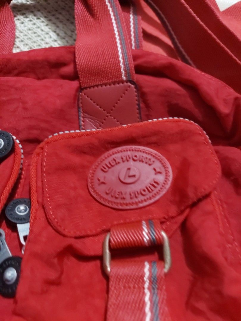 Red Anello Tote Bag and Red Shoulder Bag Bundle (Category: Tote Bags) located in Quezon City. Submitted by never_a_clutter (Listing ID 1469521952, Image 3). Description: - Bundle includes 2 versatile red bags - Bag 1: Large Anello canvas tote bag with bold white lettering - Bag 2: Ulex Brand Compact red fabric shoulder bag featuring multiple zippered front pockets and a round logo badge - Excellent daily carry options for work, school, or casual 