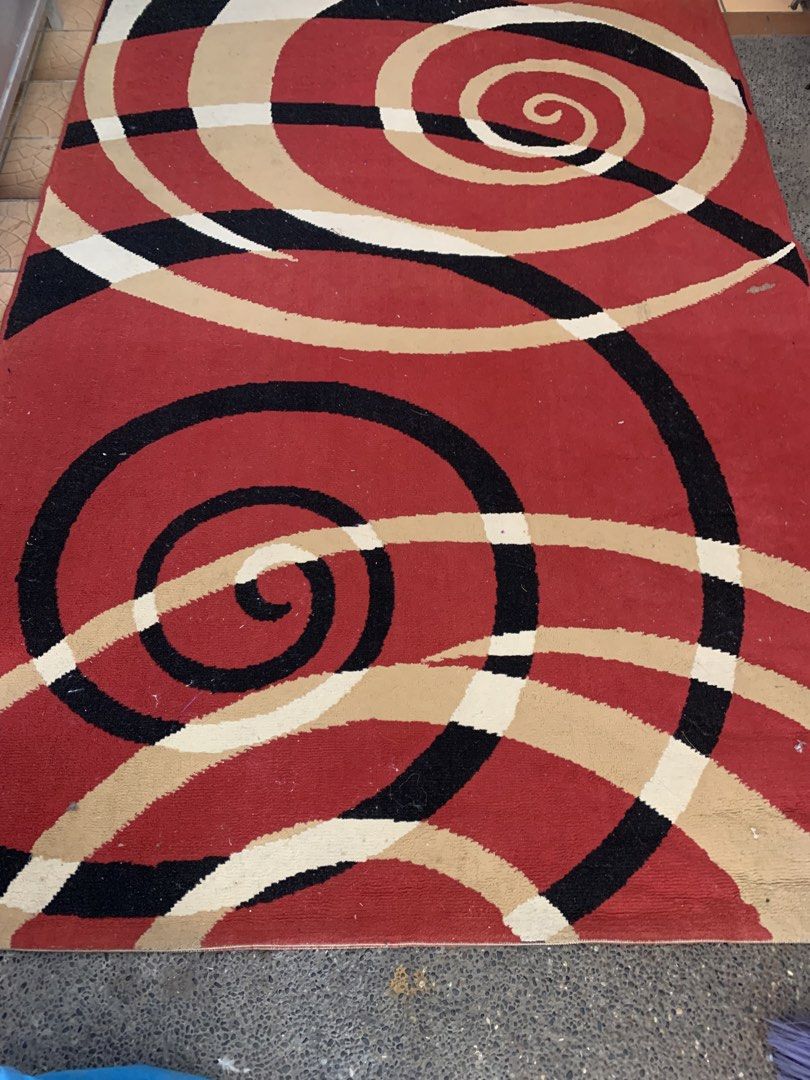 Red Black Cream Swirl Pattern Rug (Category: Carpets, Mats & Flooring) located in Bulacan. Submitted by heartlove_holb (Listing ID 1469421871, Image 2). Description: - Eye-catching spiral and swirl pattern with a bold red background - Modern mix of black, beige, and cream curves - Heavyweight fabric construction that lays flat nicely - Features clean, finished edges all around - Perfect statement piece for living rooms or bedrooms.