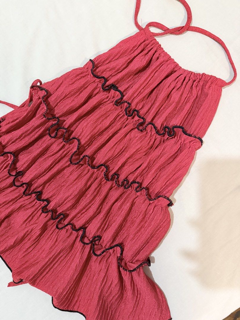 Red black Halter Top Tiered Ruffle Layered Summer backless (Category: Sleeveless) located in Paranaque City. Submitted by hannahking36 (Listing ID 1469540107, Image 2). Description: - Pink halter top with 3 tiered layers - Crinkle texture fabric with stylish black lettuce trim on every tier - Adjustable halter neck ties and back ties for a custom fit - Lightweight and breathable material, ideal for warm weather - Condition: Brand new - Shipping: 