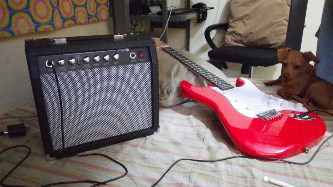 Red Electric Guitar With Stage Amplifier (Category: Musical Instruments) located in Manila. Submitted by renz23.716 (Listing ID 1469504009, Image 2). Description: - Bright red electric guitar with classic Strat-style body and white pickguard - 6-string setup, ideal for beginners and practice sessions - Stage guitar amplifier featuring input, volume, drive, treble, middle, bass controls,and power switch Amplifier Brand: Stage 1 220V~60Hz Distortio