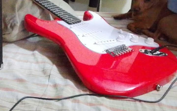 Red Electric Guitar With Stage Amplifier (Category: Musical Instruments) located in Manila. Submitted by renz23.716 (Listing ID 1469504009, Image 3). Description: - Bright red electric guitar with classic Strat-style body and white pickguard - 6-string setup, ideal for beginners and practice sessions - Stage guitar amplifier featuring input, volume, drive, treble, middle, bass controls,and power switch Amplifier Brand: Stage 1 220V~60Hz Distortio
