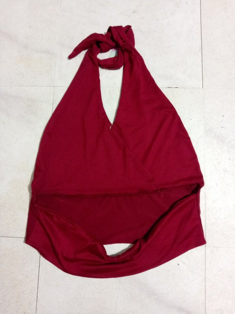 Red halter top backless crop top M-L (Category: Sleeveless) located in Taguig. Submitted by anika_francine (Listing ID 1469493555, Image 3). Description: - Condition: Brand new with tags (never worn) - Color: Deep red - Style: Halter top with neck tie closure - Design: Deep V-neck wrap front with a wide supportive band at the bottom - Fabric: Soft and stretchy for a comfortable fit.