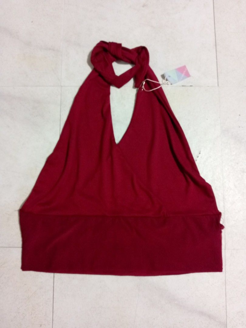 Red halter top backless crop top M-L (Category: Sleeveless) located in Taguig. Submitted by anika_francine (Listing ID 1469493555, Image 2). Description: - Condition: Brand new with tags (never worn) - Color: Deep red - Style: Halter top with neck tie closure - Design: Deep V-neck wrap front with a wide supportive band at the bottom - Fabric: Soft and stretchy for a comfortable fit.