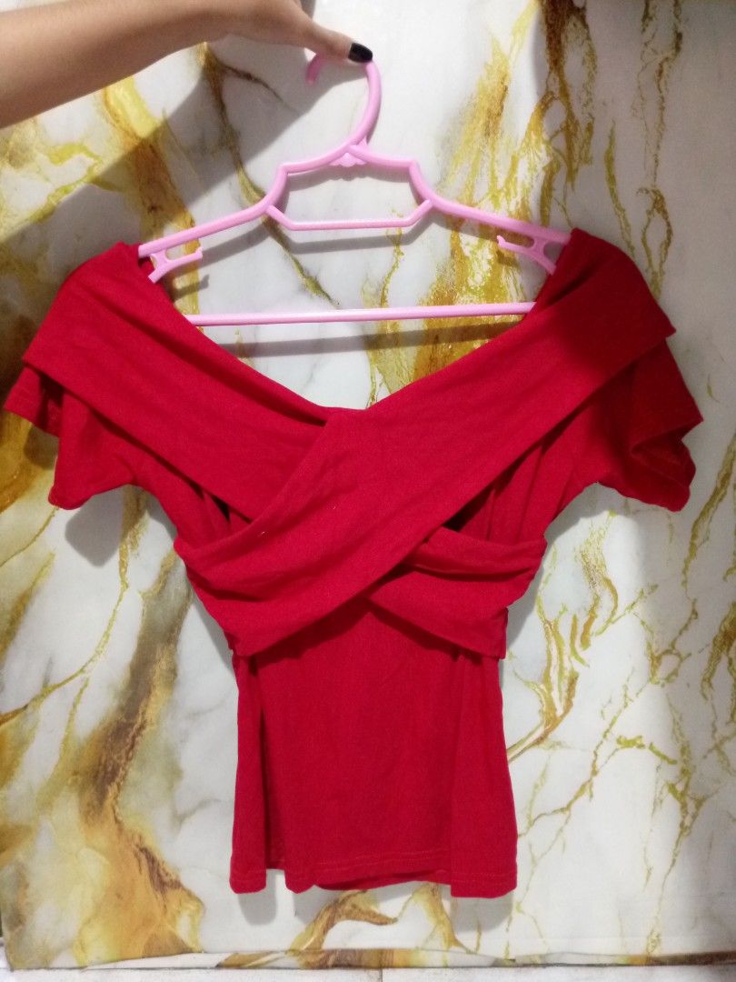 Red off-shoulder crossover top S-M (Category: Blouses) located in Taguig. Submitted by anika_francine (Listing ID 1469493757, Image 1). Description: - Color: Bright red - Style: Off-shoulder with front crossover strap design - Fit: Fitted, short sleeves, waist-length - Material: Stretchy and comfortable - Condition: Excellent, clean, no stains or rips.
