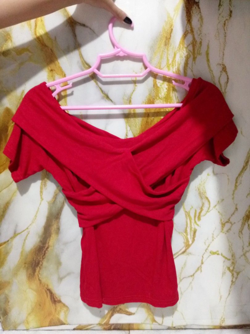 Red off-shoulder crossover top S-M (Category: Blouses) located in Taguig. Submitted by anika_francine (Listing ID 1469493757, Image 2). Description: - Color: Bright red - Style: Off-shoulder with front crossover strap design - Fit: Fitted, short sleeves, waist-length - Material: Stretchy and comfortable - Condition: Excellent, clean, no stains or rips.