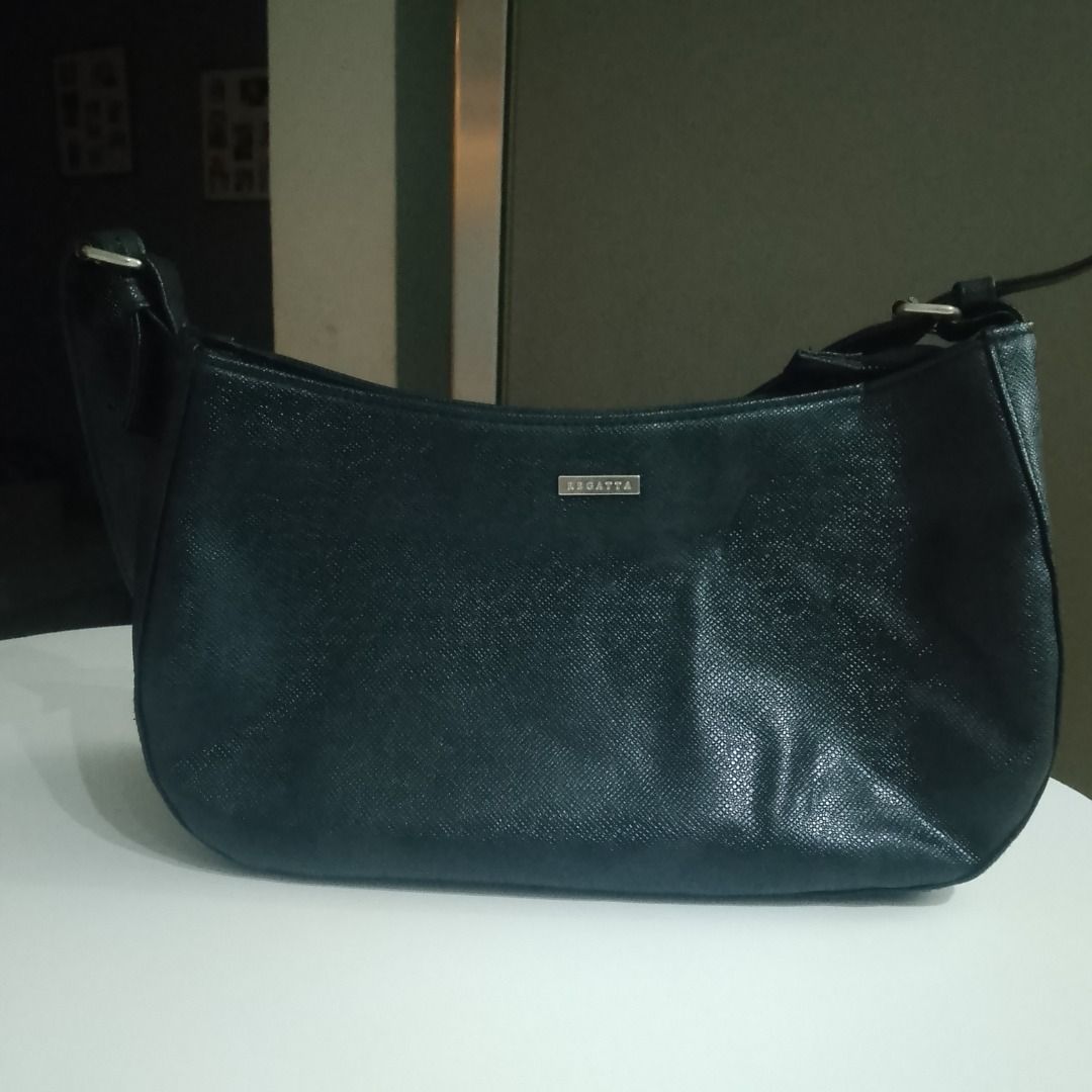 Regatta dark green textured shoulder bag (Category: Shoulder Bags) located in Roxas City. Submitted by demalatagiboy (Listing ID 1469489521, Image 2). Description: - Brand: Regatta - Color: Dark green - Material: Textured faux leather with silver-tone hardware - Closure: Simple and secure zip closure - Features: Metallic logo plaque on the front, clean interior lining, and an adjustable strap - Capacity: Practical size for daily essentials (phone