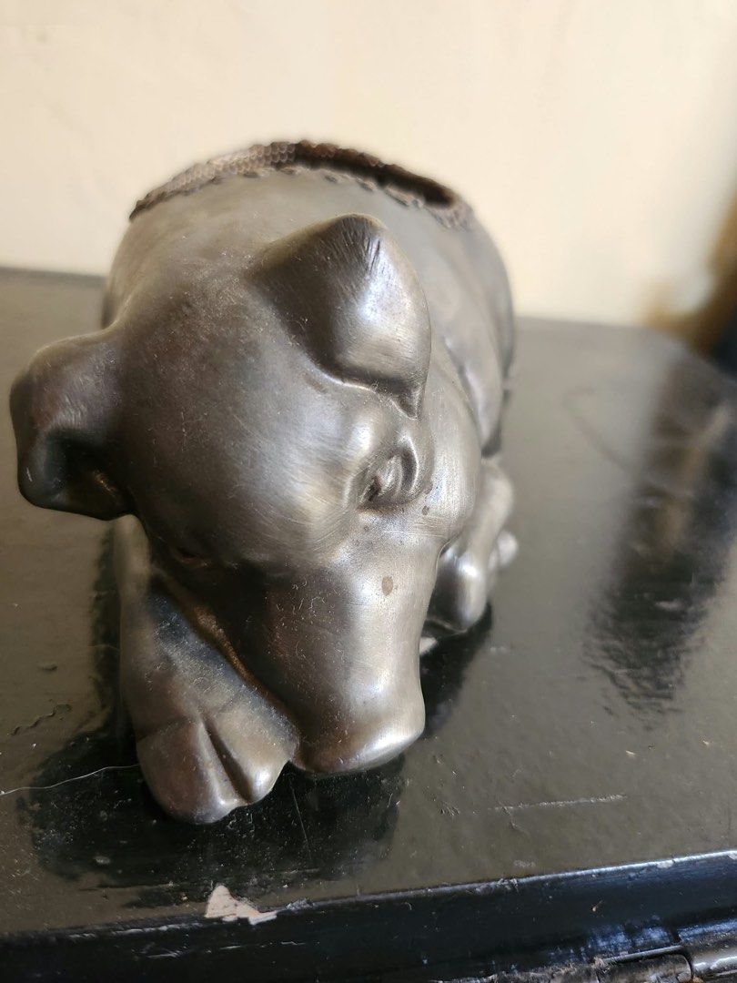 Resting Pig Tealight Candle Holder Silver Tone (Category: Home Fragrance) located in Marikina City. Submitted by boutiquekoh (Listing ID 1469435556, Image 2). Description: - Metallic silver finish with textured trim - Includes a metal tea light cup on the back - Solid weight and sits flat on surfaces - Cute resting pig design - Perfect for home decor or gifting.
