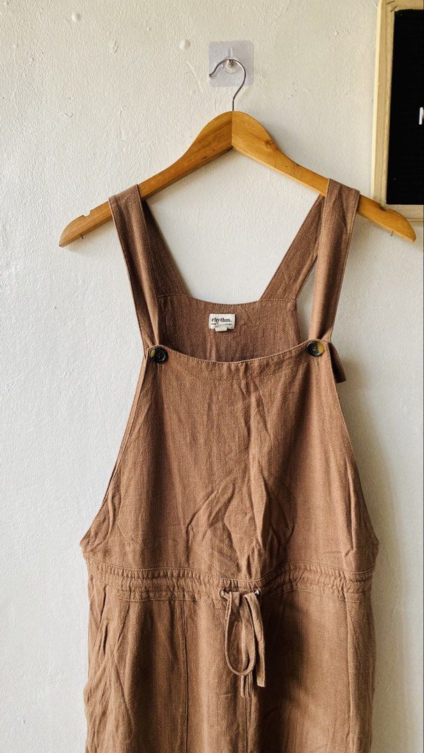 Rhythm Brown Jumpsuit Overalls (Category: Jumpsuits) located in Caloocan City. Submitted by lovemyclothes21 (Listing ID 1469465673, Image 3). Description: - Size: Medium - Color: Brown - Material: Textured cotton-linen blend - Straps: Adjustable with tortoise buttons - Waist: Drawstring for an adjustable fit - Pockets: Front patch pockets - Fit: Relaxed and breezy - Style: Great casual staple for warm weather.