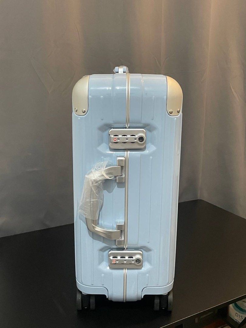 Rimowa light blue hardshell suitcase with gold hardware (Category: Luggage) located in Manila. Submitted by thelux2026 (Listing ID 1469567922, Image 3). Description: - Authentic Rimowa hardshell suitcase in a chic light blue color - Premium gold-tone metal corners and front brand plaque - Secure dual combination locks for safe traveling - Clean ribbed exterior design with sturdy side hinges - Smooth multi-wheel setup for effortless mobility - Sid