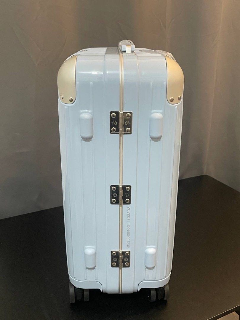 Rimowa light blue hardshell suitcase with gold hardware (Category: Luggage) located in Manila. Submitted by thelux2026 (Listing ID 1469567922, Image 2). Description: - Authentic Rimowa hardshell suitcase in a chic light blue color - Premium gold-tone metal corners and front brand plaque - Secure dual combination locks for safe traveling - Clean ribbed exterior design with sturdy side hinges - Smooth multi-wheel setup for effortless mobility - Sid