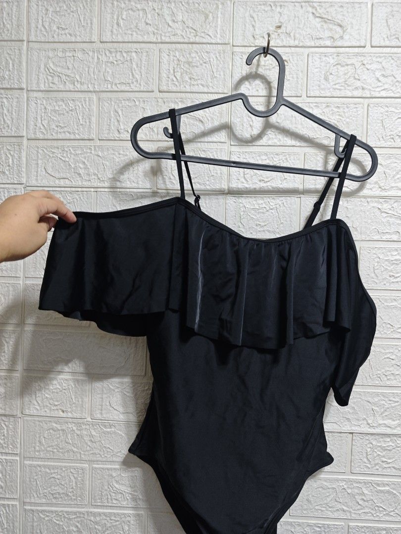 Rivers Black Ruffle One-Piece Swimsuit Size 14 (Category: Bikinis & Swimsuits) located in Pasay City. Submitted by clotheslinemanila (Listing ID 1469475596, Image 2). Description: - Brand: Rivers - Style: One-piece swimsuit - Color: Solid black - Size: 14 - Features: Thin adjustable straps, ruffled chest overlay draped over arms - Origin: Made in China - Condition: Excellent.