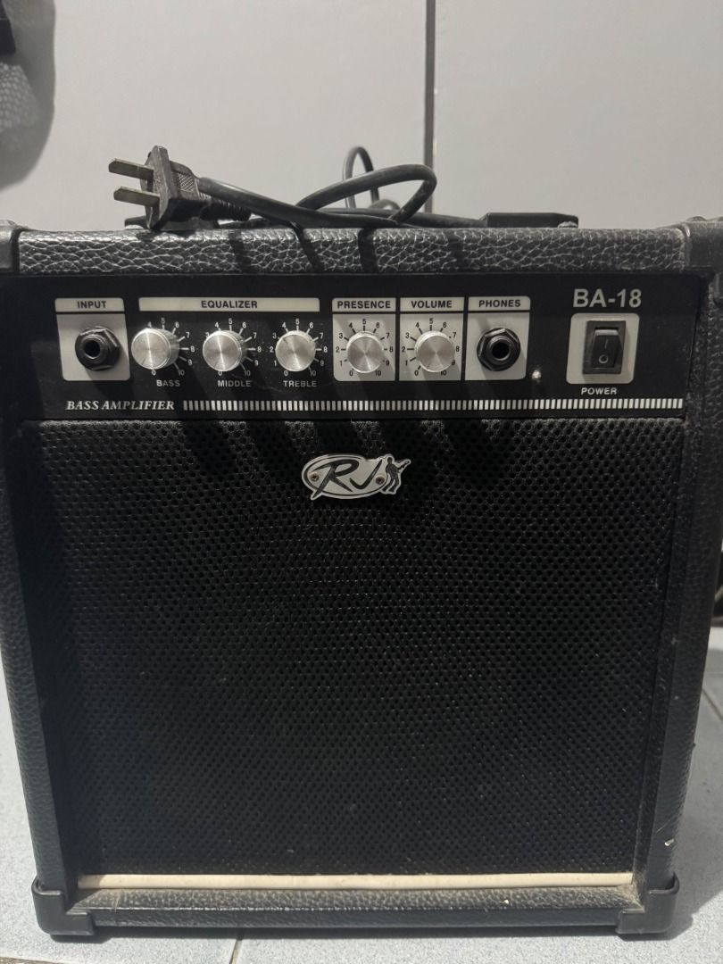 RJ BA-18 18W Bass Amplifier (Category: Musical Instruments) located in Las Pinas. Submitted by cxvjm (Listing ID 1469567553, Image 1). Description: - Brand/Model: RJ BA-18 Bass Amplifier - Power: 18 watts output (28W power consumption, 220VAC 50Hz) - Tone Control: 3-band equalizer (Bass, Middle, Treble) plus Presence and Volume knobs - Connectivity: Standard input jack and built-in headphone output slot - Design: Convenient right-side power switc