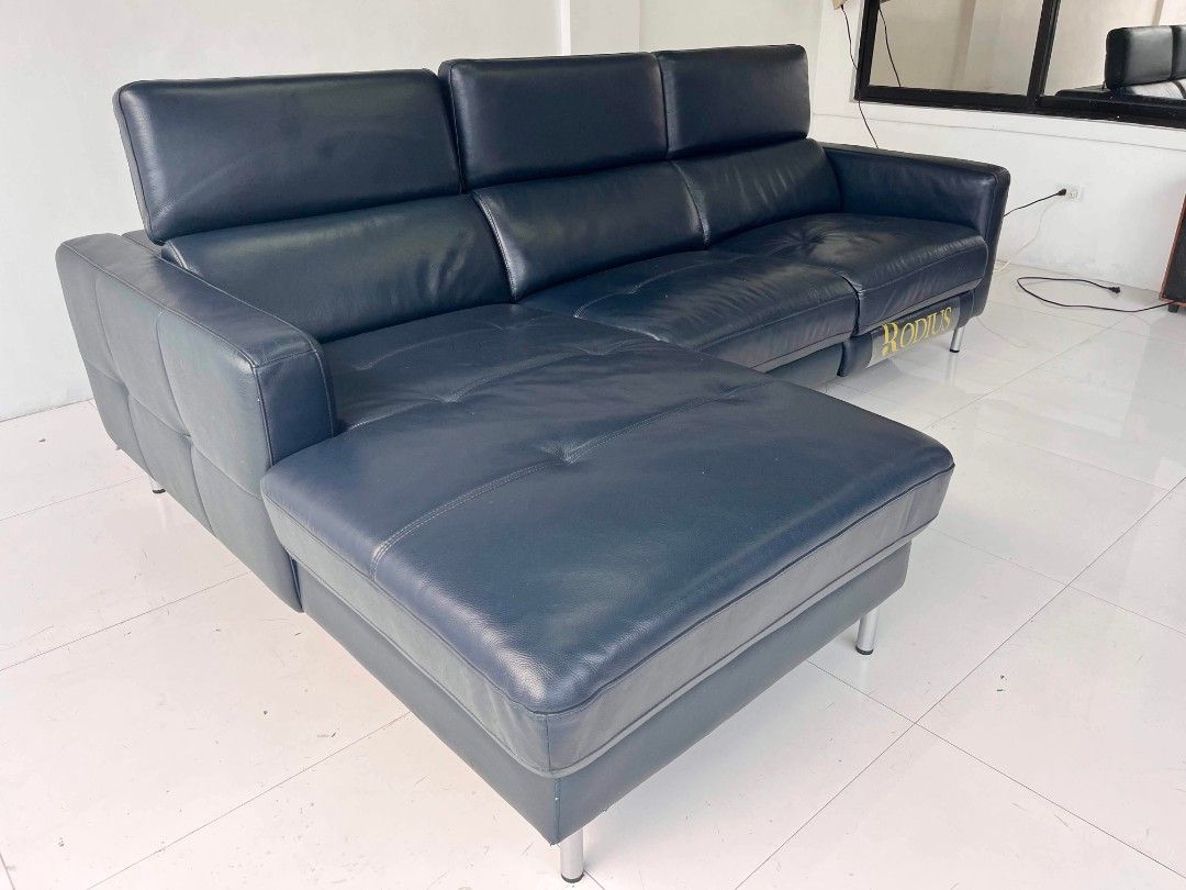 Rodius Navy Blue Leather Sectional Sofa with Recliner (Category: Sofas) located in Manila. Submitted by roveeeeelen_06 (Listing ID 1469571983, Image 2). Description: - Brand/Model: Rodius navy blue leather sectional sofa - Features: Built-in recliner mechanism and comfortable chaise lounge extension - Design: Modern chrome metal legs - Condition: Plush cushioning with standard leather wear - Ideal for: Upgrading your living room space.