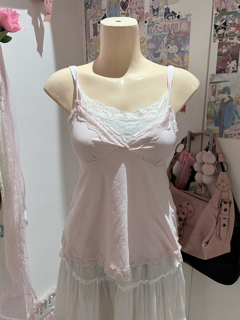 Romwe Pink Lace Trim Cami Top (Category: Sleeveless) located in Manila. Submitted by jael_thrift (Listing ID 1469447794, Image 2). Description: - Brand: Romwe - Size: XS-S - Color: Soft pastel pink - Style: Coquette aesthetic, sweetheart neckline, and delicate lace trim - Features: Thin adjustable spaghetti straps - Versatility: Great for layering over tees or wearing on its own.
