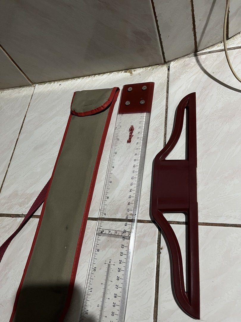 Rotring Drawing Ruler Set with Carrying Case 687-536 (Category: Stationery & School Supplies) located in Manila. Submitted by mae009 (Listing ID 1469512070, Image 1). Description: Price Negotiable if sure buyer - Brand: Rotring (Model 687-536) - Condition: Clean with clear, easy-to-read markings - Inclusions: Long clear ruler, red sliding attachment, and khaki canvas carrying bag with red trim and shoulder strap - Ideal for: Technical drawing, dr