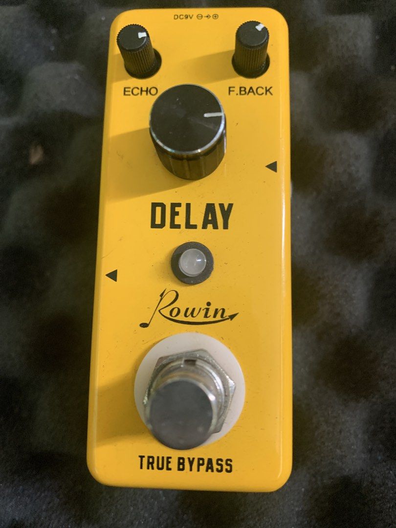 Rowin Delay Guitar Effects Pedal True Bypass Yellow (Category: Musical Instruments) located in Manila. Submitted by emenem.m (Listing ID 1469454189, Image 1). Description: - Brand/Model: Rowin Guitar Delay Pedal in bright yellow - Design: Compact mini enclosure with true bypass switching - Controls: Three knobs for Echo, Feedback, and Delay Time - Power: Standard DC 9V power jack - Condition: Fully working with minor scuffs from normal board use.